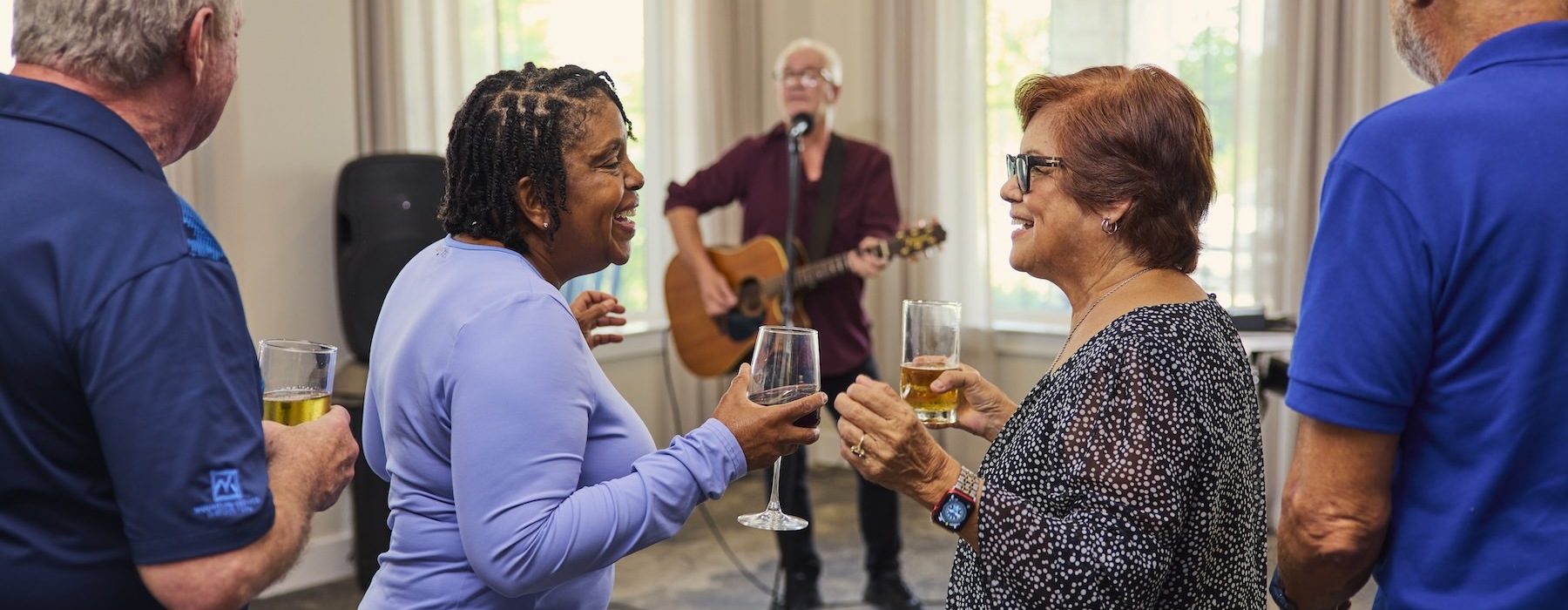 The essence of exceptional living a group of people holding drinks and dancing to music