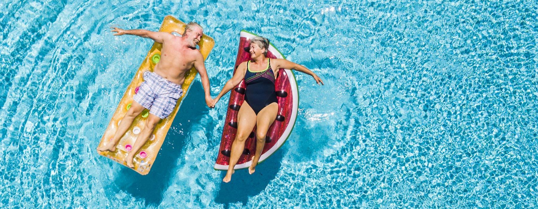 a couple of people in swimsuits in the water