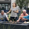 a group of people laughing and holding drinks