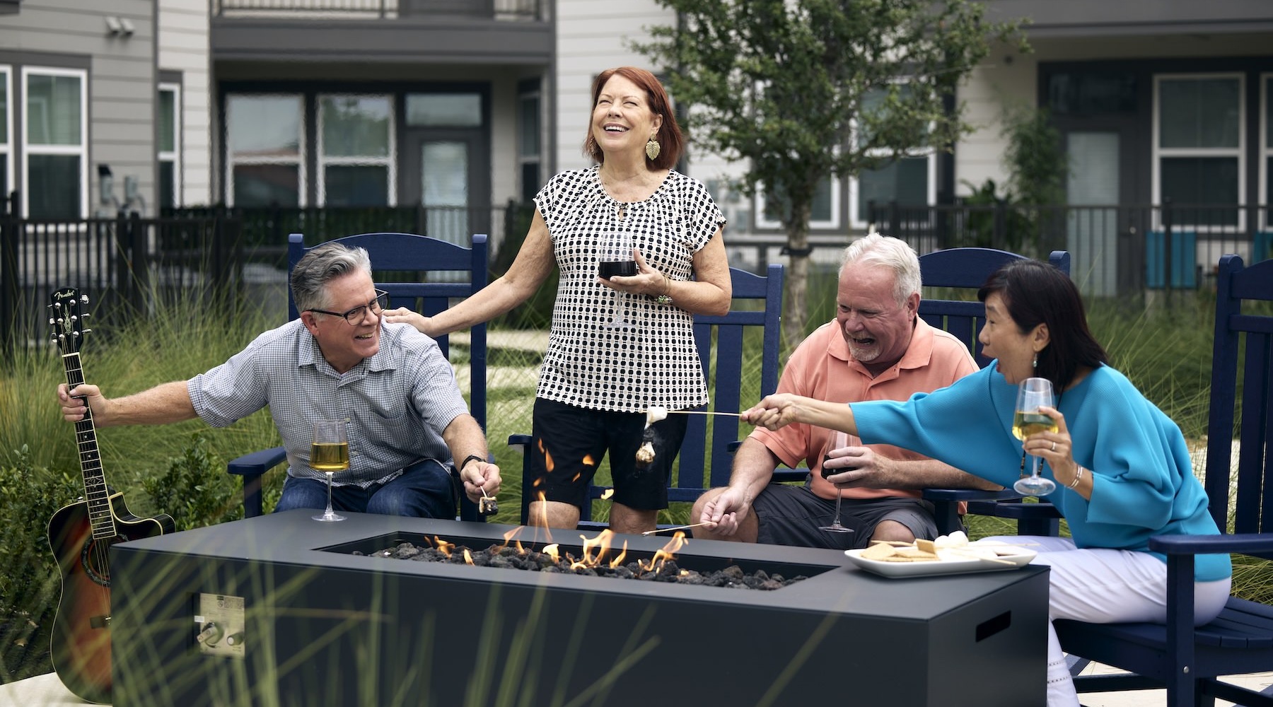 Close to the center of everything a group of people laughing and holding drinks